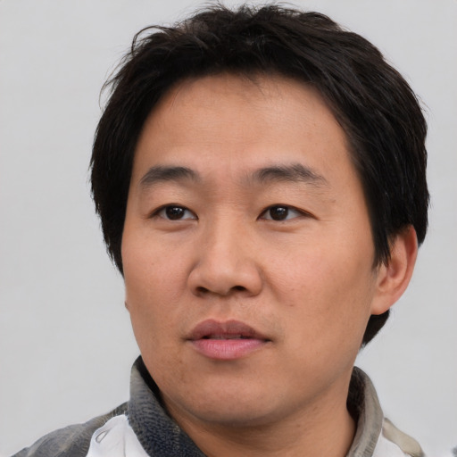 Neutral asian young-adult male with short  brown hair and brown eyes