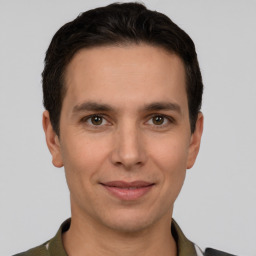 Joyful white young-adult male with short  brown hair and grey eyes