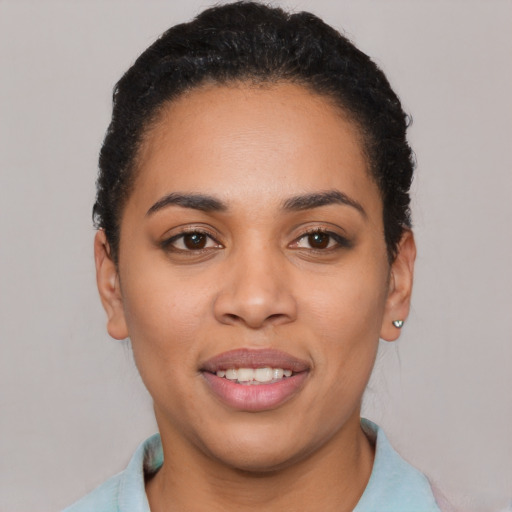 Joyful latino young-adult female with short  black hair and brown eyes