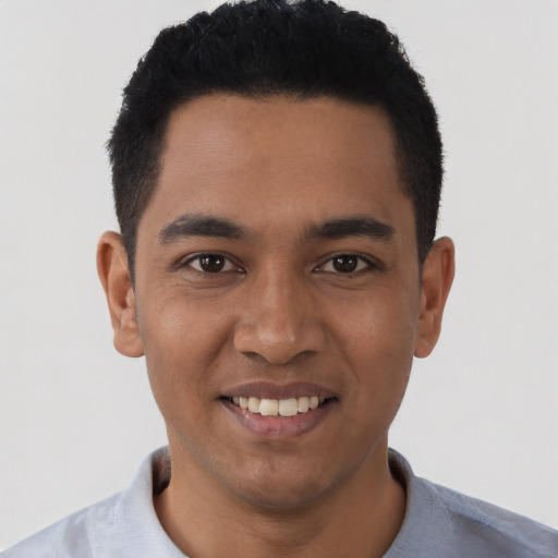 Joyful latino young-adult male with short  black hair and brown eyes