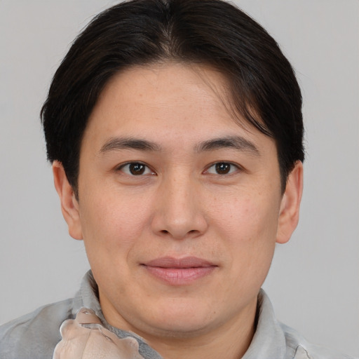 Joyful asian young-adult male with short  brown hair and brown eyes