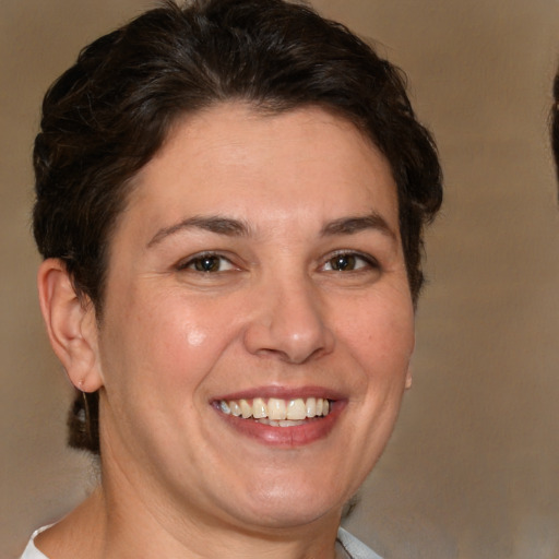 Joyful white adult female with short  brown hair and brown eyes