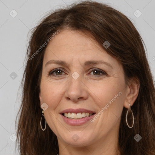 Joyful white adult female with long  brown hair and brown eyes