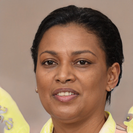 Joyful black adult female with short  black hair and brown eyes