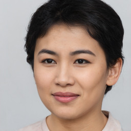 Joyful asian young-adult female with short  brown hair and brown eyes