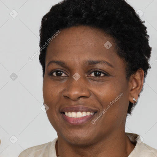 Joyful black young-adult female with short  black hair and brown eyes