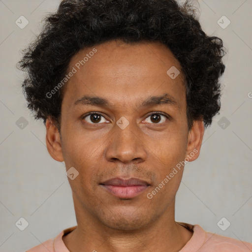 Joyful latino young-adult male with short  brown hair and brown eyes