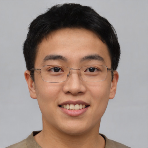 Joyful asian young-adult male with short  black hair and brown eyes