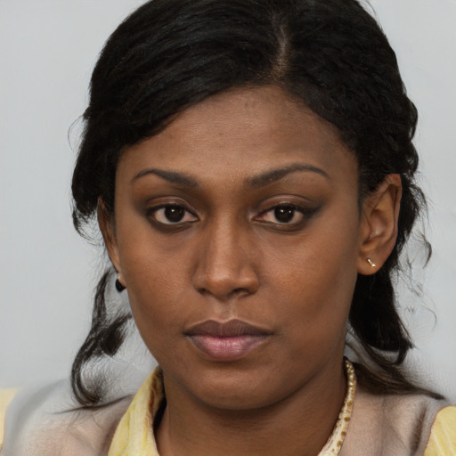 Neutral black young-adult female with long  brown hair and brown eyes