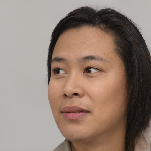 Joyful asian young-adult female with medium  brown hair and brown eyes
