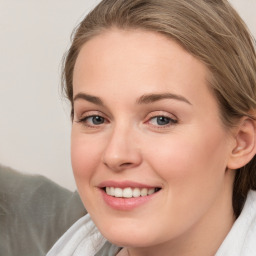 Joyful white young-adult female with medium  brown hair and blue eyes