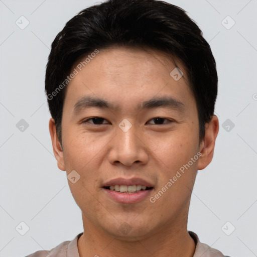 Joyful asian young-adult male with short  brown hair and brown eyes