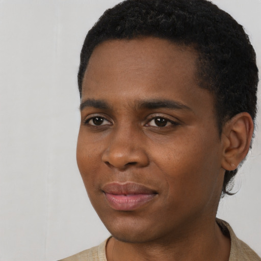 Joyful black young-adult male with short  black hair and brown eyes