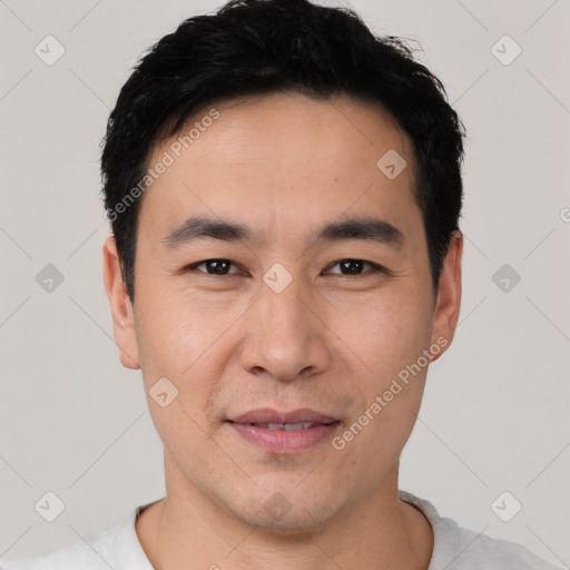 Joyful asian young-adult male with short  black hair and brown eyes