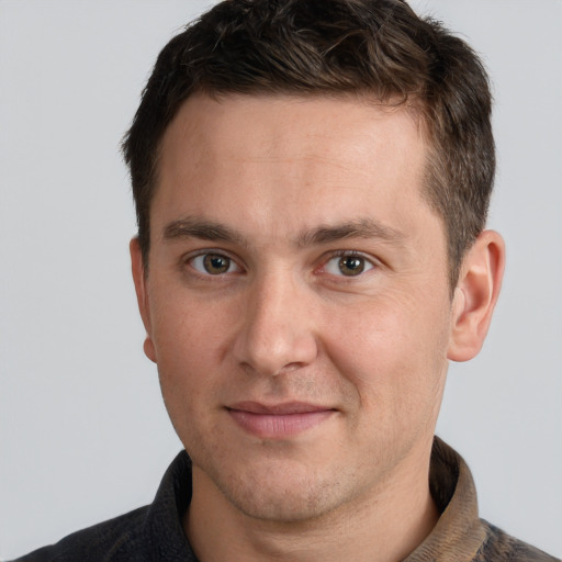 Joyful white adult male with short  brown hair and grey eyes