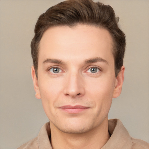 Joyful white young-adult male with short  brown hair and grey eyes