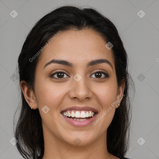 Joyful latino young-adult female with long  brown hair and brown eyes