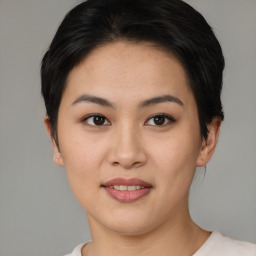 Joyful asian young-adult female with short  brown hair and brown eyes