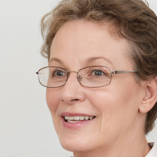 Joyful white adult female with medium  brown hair and blue eyes