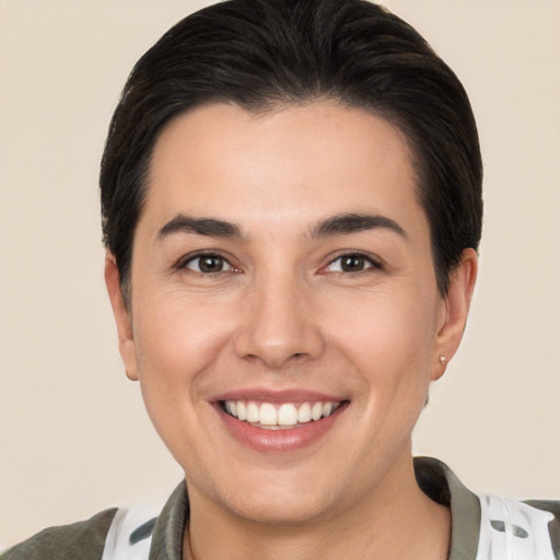 Joyful white young-adult female with short  brown hair and brown eyes