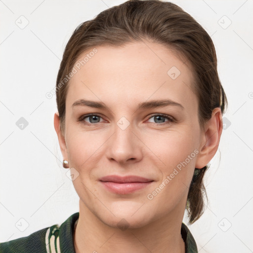 Joyful white young-adult female with medium  brown hair and grey eyes