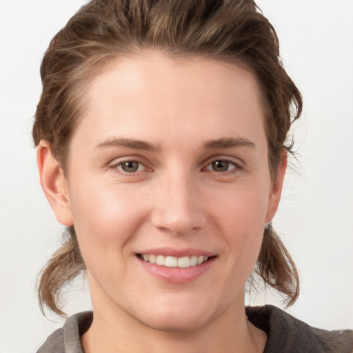 Joyful white young-adult female with medium  brown hair and grey eyes