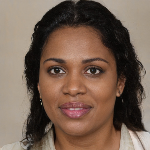 Joyful black young-adult female with medium  brown hair and brown eyes