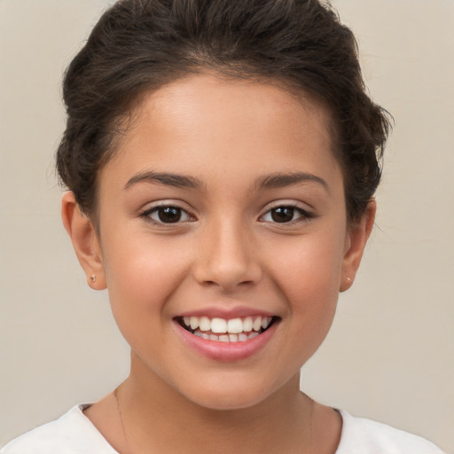 Joyful white child female with short  brown hair and brown eyes