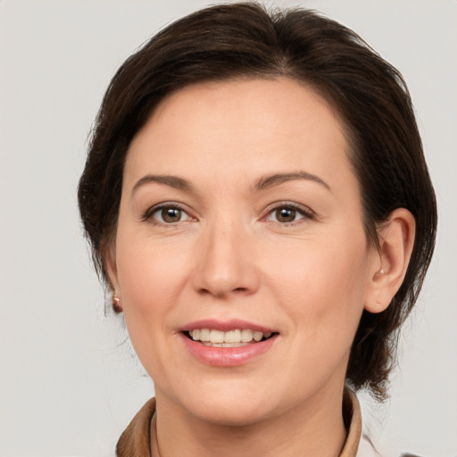 Joyful white adult female with medium  brown hair and brown eyes