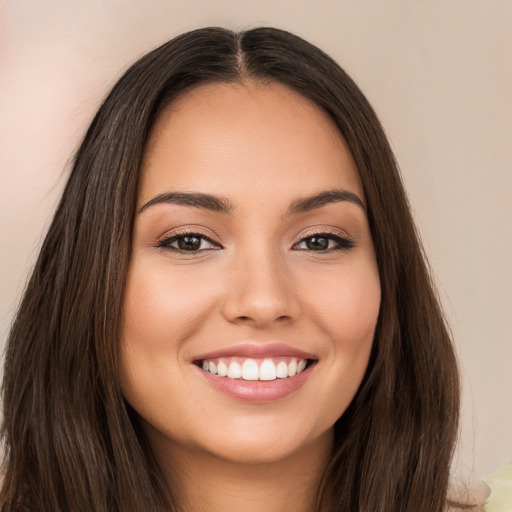 Joyful white young-adult female with long  brown hair and brown eyes