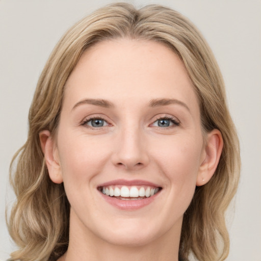 Joyful white young-adult female with medium  brown hair and blue eyes