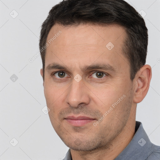 Joyful white adult male with short  brown hair and brown eyes