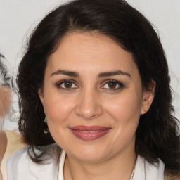 Joyful white adult female with medium  brown hair and brown eyes