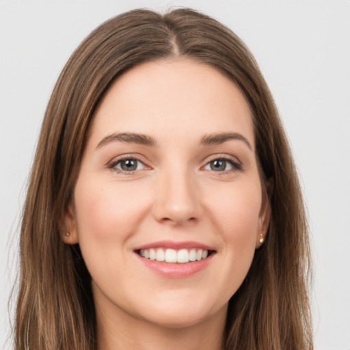 Joyful white young-adult female with long  brown hair and grey eyes