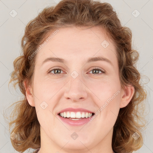 Joyful white young-adult female with medium  brown hair and green eyes