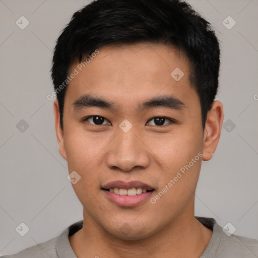 Joyful asian young-adult male with short  black hair and brown eyes