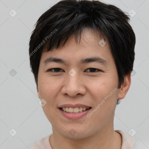 Joyful asian young-adult male with short  brown hair and brown eyes