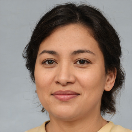 Joyful latino adult female with medium  brown hair and brown eyes