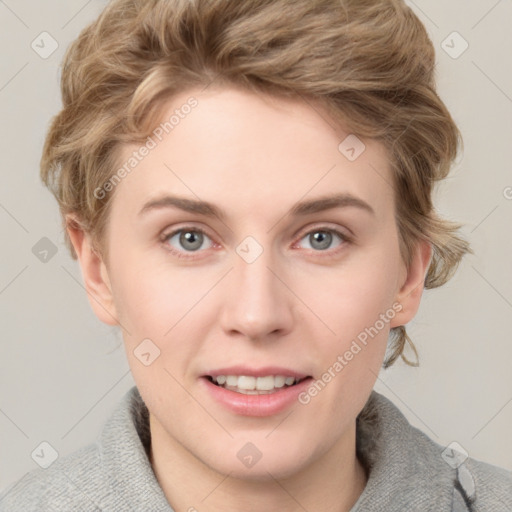 Joyful white young-adult female with short  brown hair and blue eyes