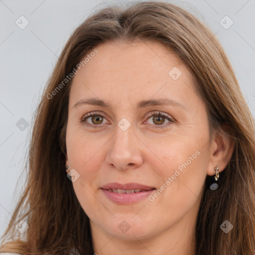 Joyful white adult female with long  brown hair and grey eyes