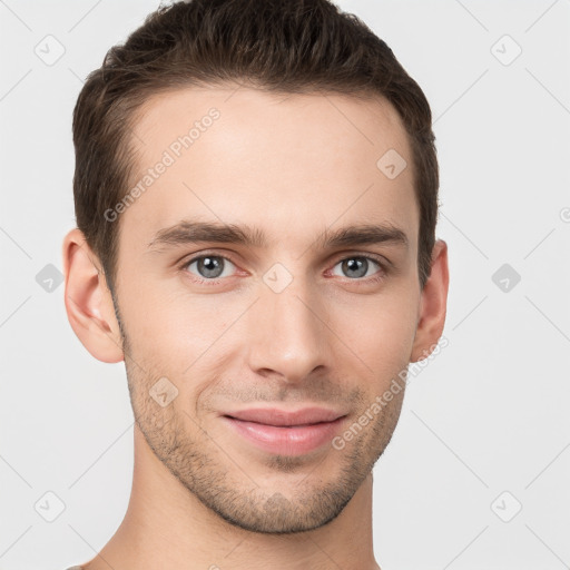 Joyful white young-adult male with short  brown hair and grey eyes