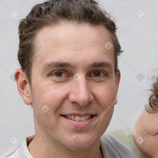 Joyful white adult male with short  brown hair and brown eyes