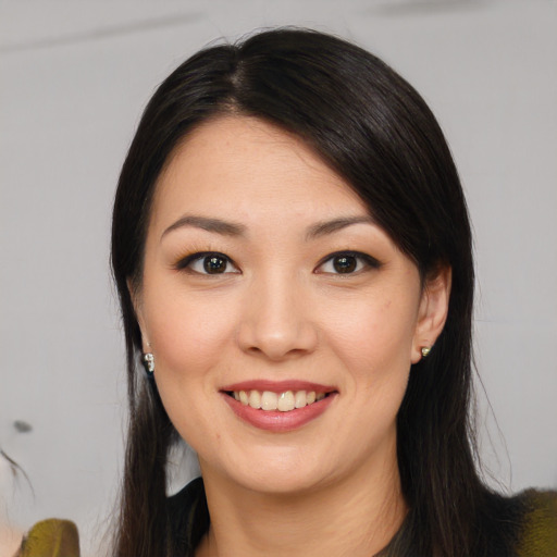 Joyful white young-adult female with long  black hair and brown eyes