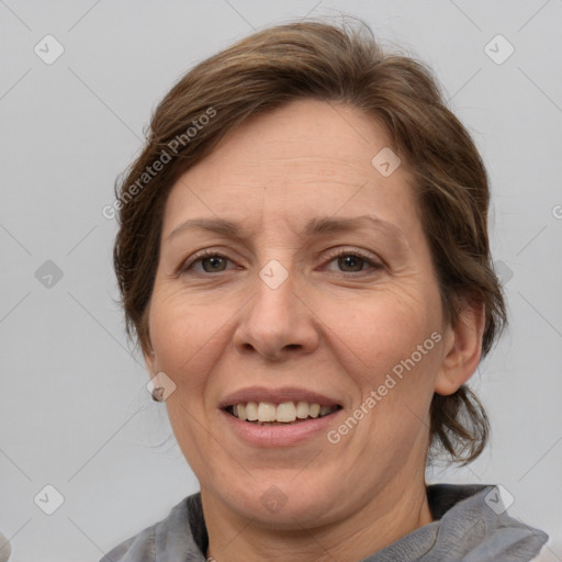 Joyful white adult female with medium  brown hair and grey eyes