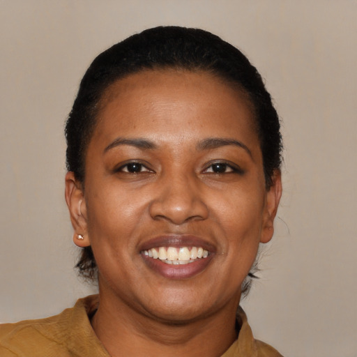 Joyful latino young-adult female with short  black hair and brown eyes