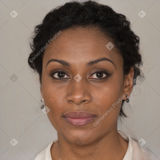 Joyful black adult female with short  brown hair and brown eyes