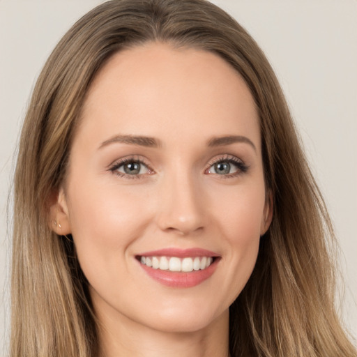 Joyful white young-adult female with long  brown hair and brown eyes