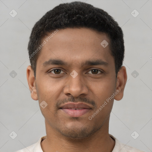 Joyful black young-adult male with short  black hair and brown eyes