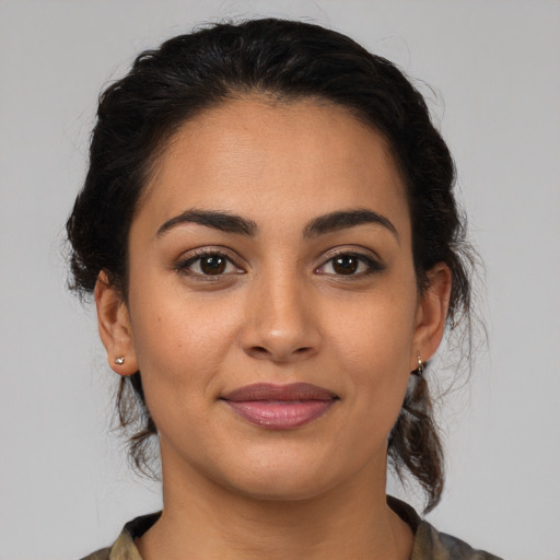 Joyful latino young-adult female with medium  brown hair and brown eyes