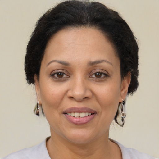 Joyful latino adult female with short  brown hair and brown eyes